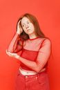 Woman in Red Long Sleeves with Hand on Head