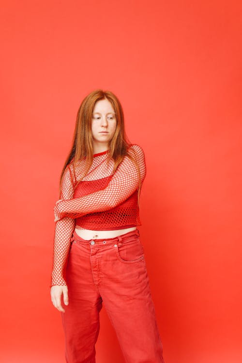 Woman in Red Pants and Shirt Looking Down
