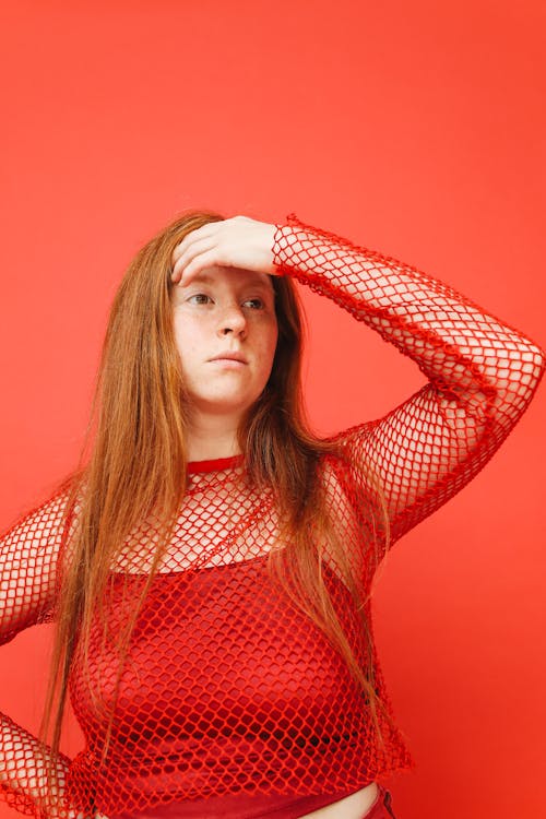 A Woman Posing in a Red Outfit