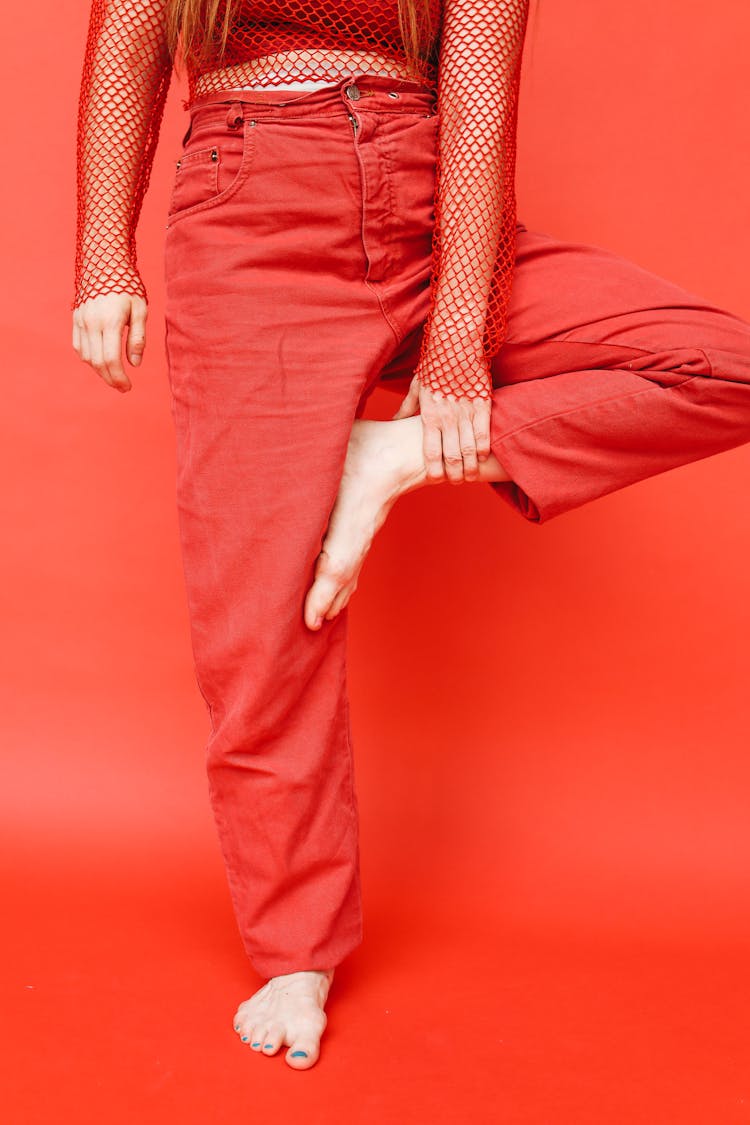 Person In Red Pants Standing On One Foot