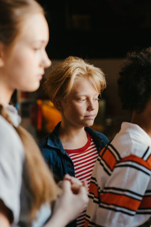 Free Portrait of thoughtful teenagers in a warm, indoor setting. Stock Photo