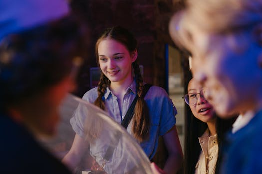 A diverse group of teenagers enjoying an engaging indoor activity. Expressions of joy and camaraderie.