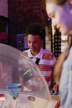 Teens having fun playing arcade games, showcasing youthful spirit and enthusiasm.