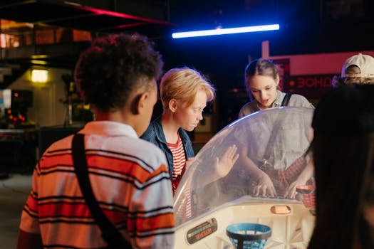 A group of teenagers having fun playing a game in an arcade setting.