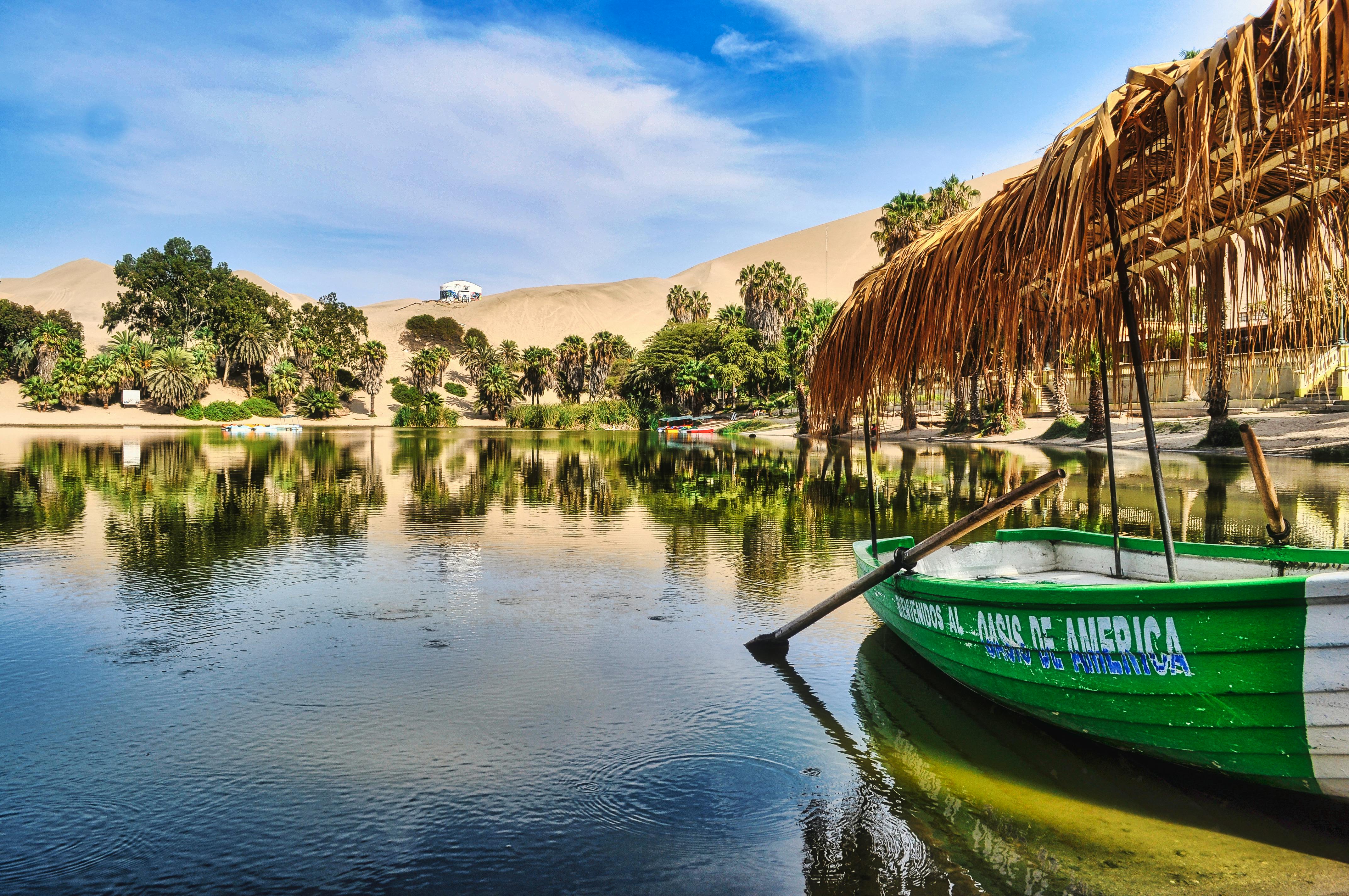 Free Green Boat on a Lake in the Middle of a Desert Stock Photo