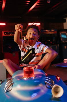 A cheerful boy enjoys a fun ride in an indoor amusement park arcade, capturing pure joy.