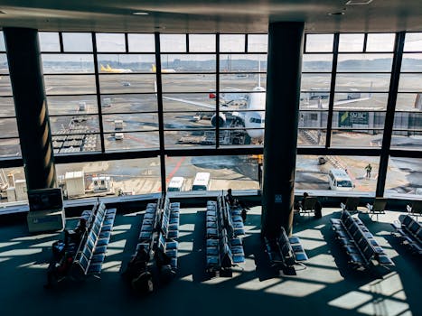Spacious airport terminal with airplane and tarmac view in Tokyo, Japan.