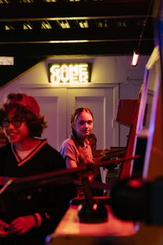 Teenagers having fun at an indoor arcade under neon lights, capturing the retro gaming vibe and youthful excitement.