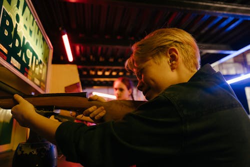 Man in Black Jacket Holding Rifle