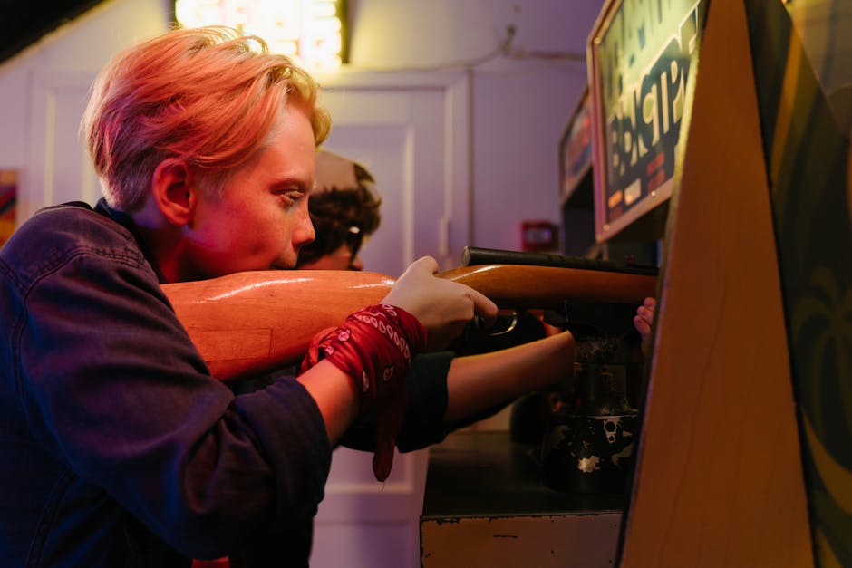 A teenager having fun playing a rifle range game in a retro-styled arcade.
