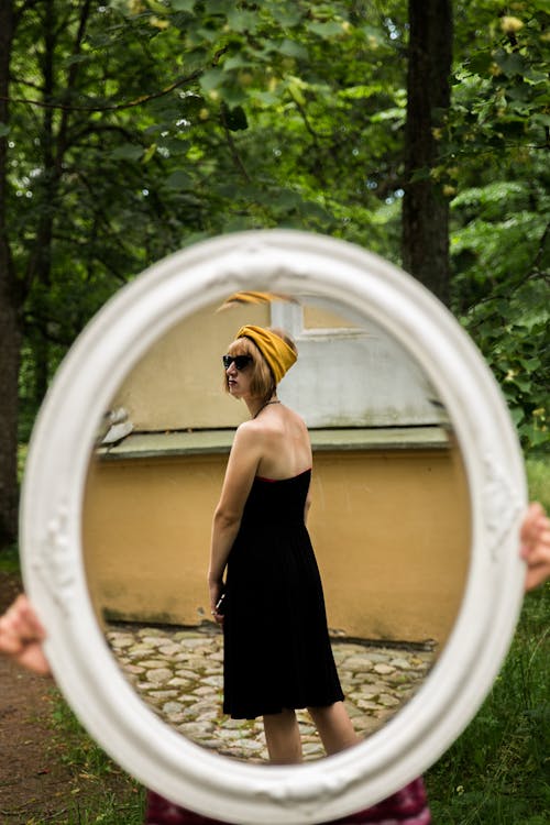 Mirror image of stylish young woman