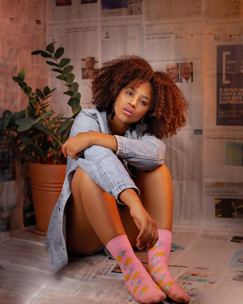 Trendy black woman in pink socks with patterns