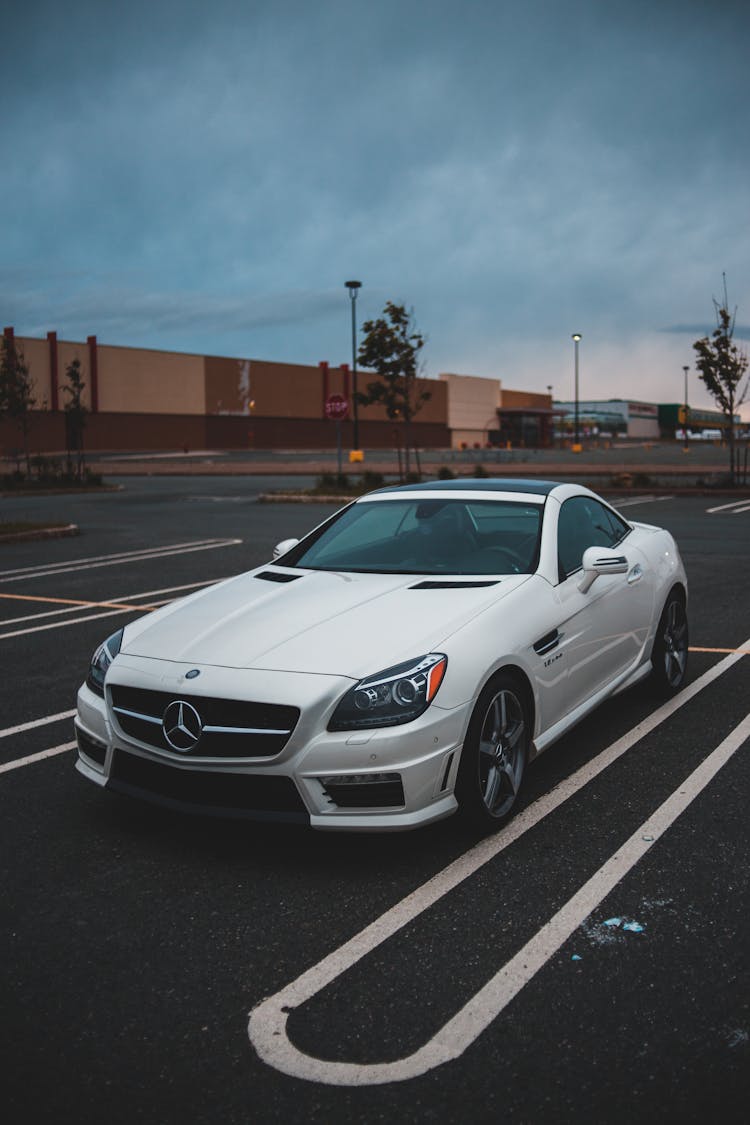 Expensive White Coupe Car Parked On Street On Overcast Day