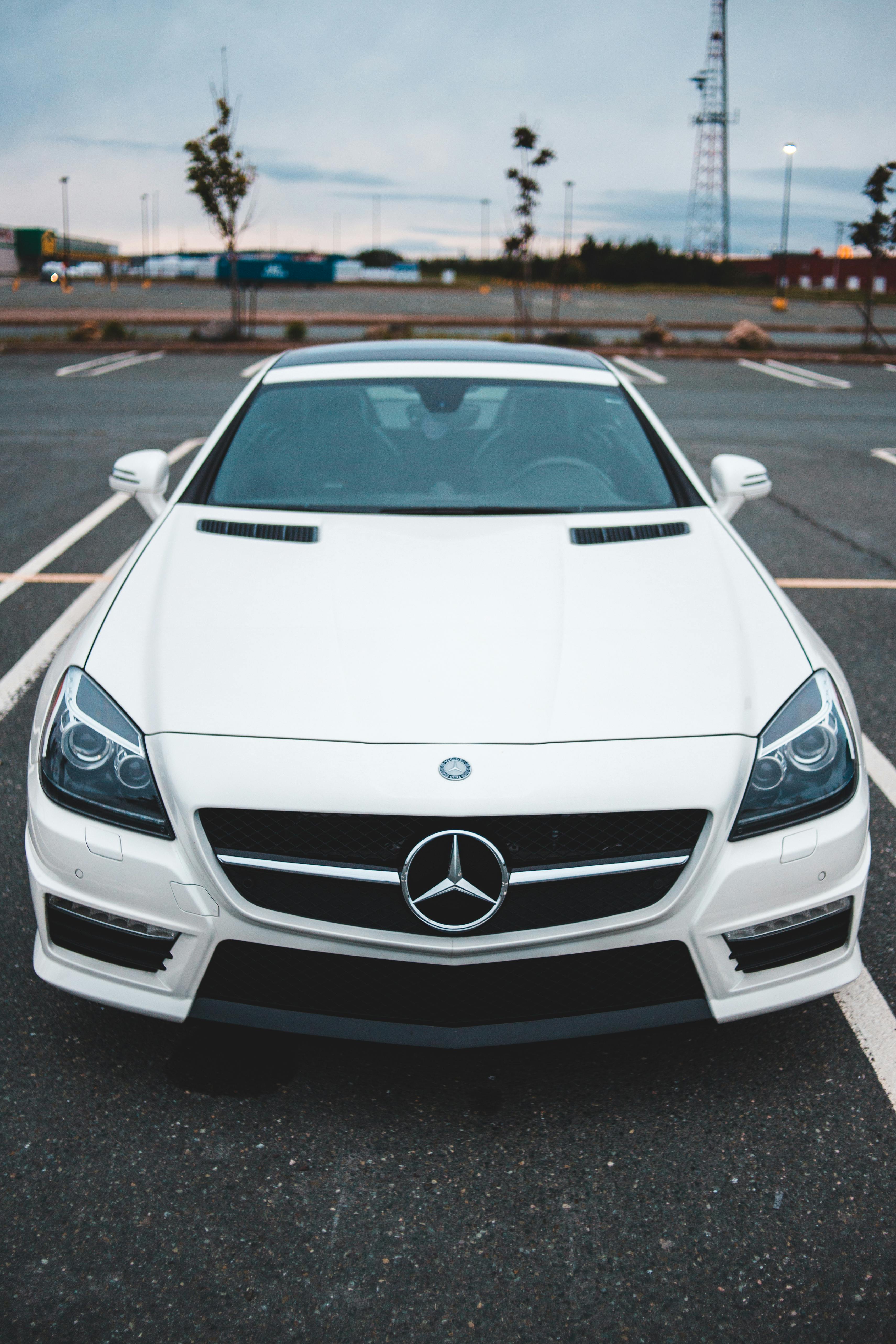 stylish luxury car parked against cloudy sky