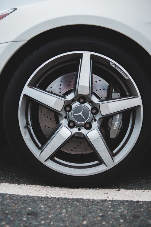 Free Tire with chrome rim of stylish expensive modern car parked on asphalt road in daylight Stock Photo