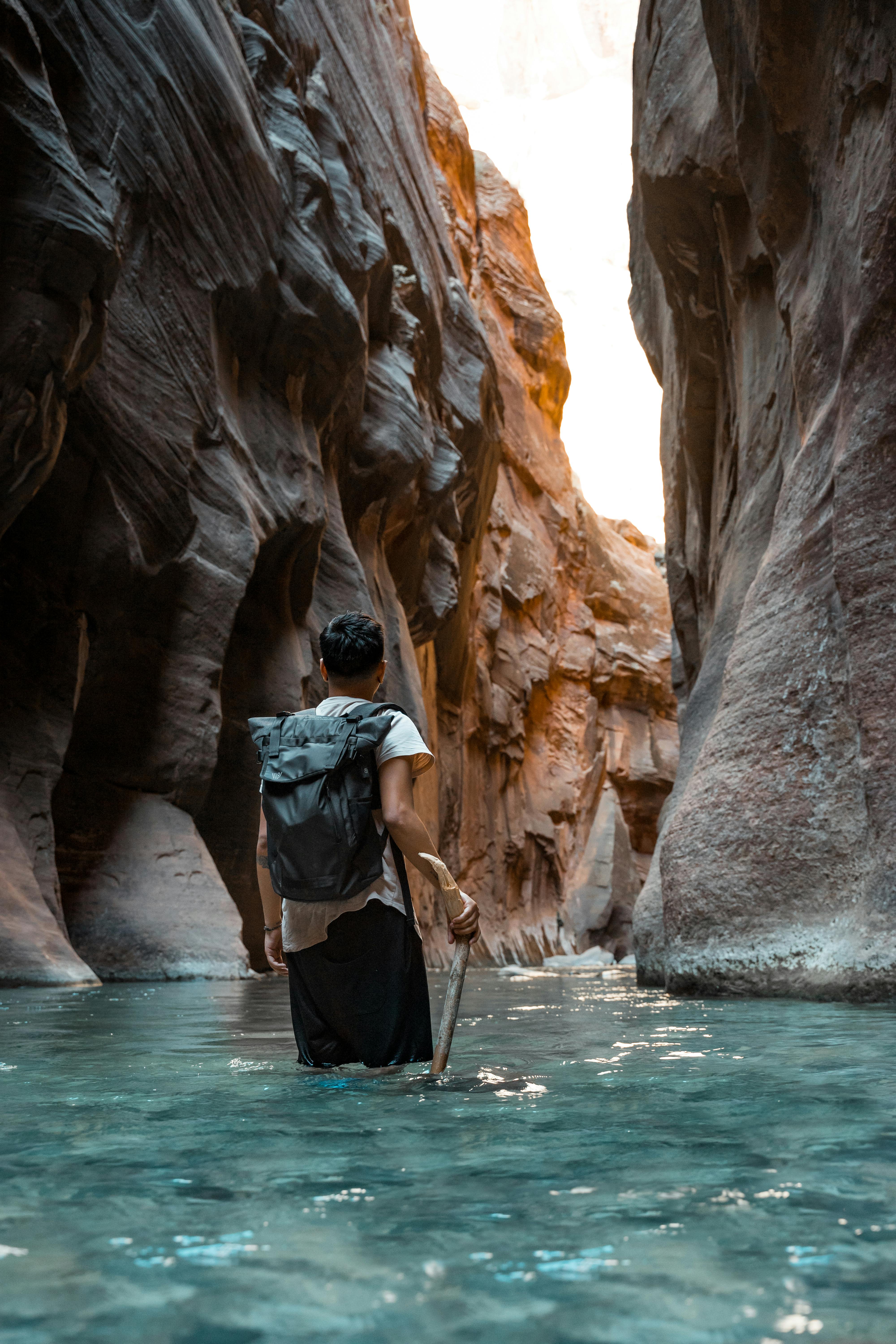 a person hiking inside a canyon in utah