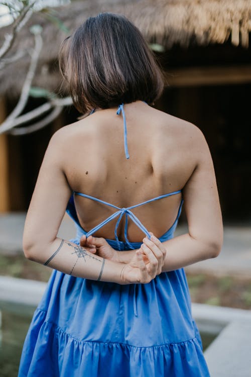 Back View of a Woman in Blue Spaghetti Strap Dress