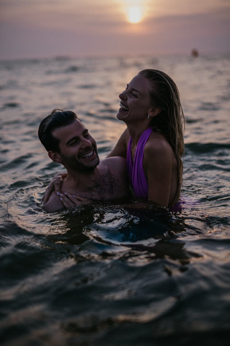 A Happy Couple Swimming In The Sea