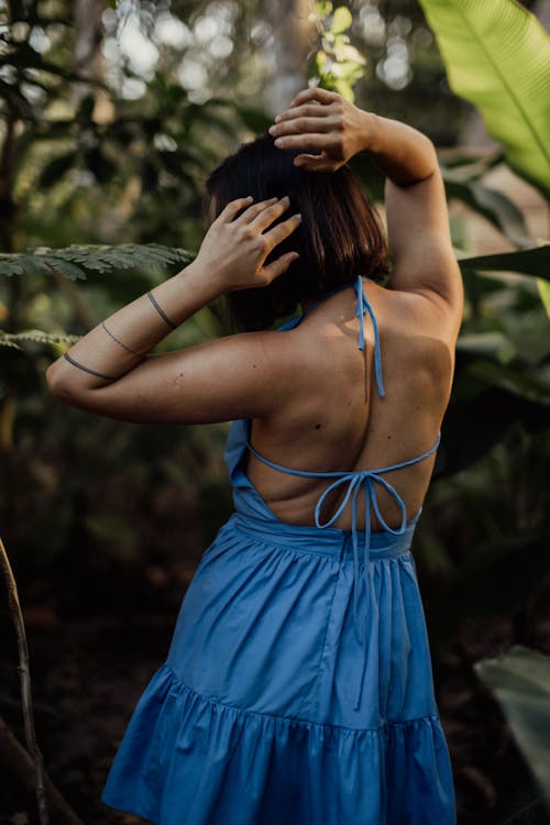 Back View of a Woman in Blue Dress Posing