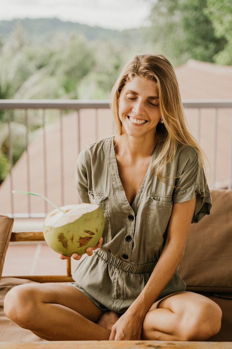 Happy Woman Holding A Coconut Fruit