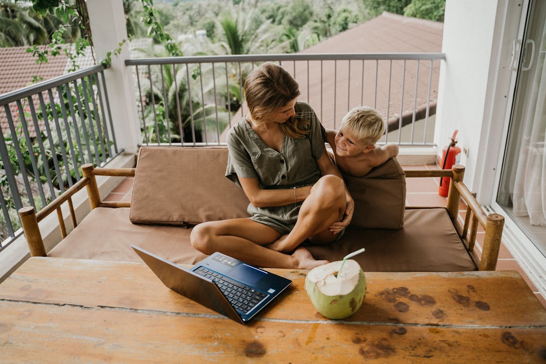 Free Mother and Son Sitting on a Sofa Stock Photo