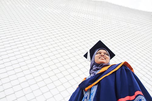 Free Woman in Blue Academic Dress and Black Academic Hat Stock Photo