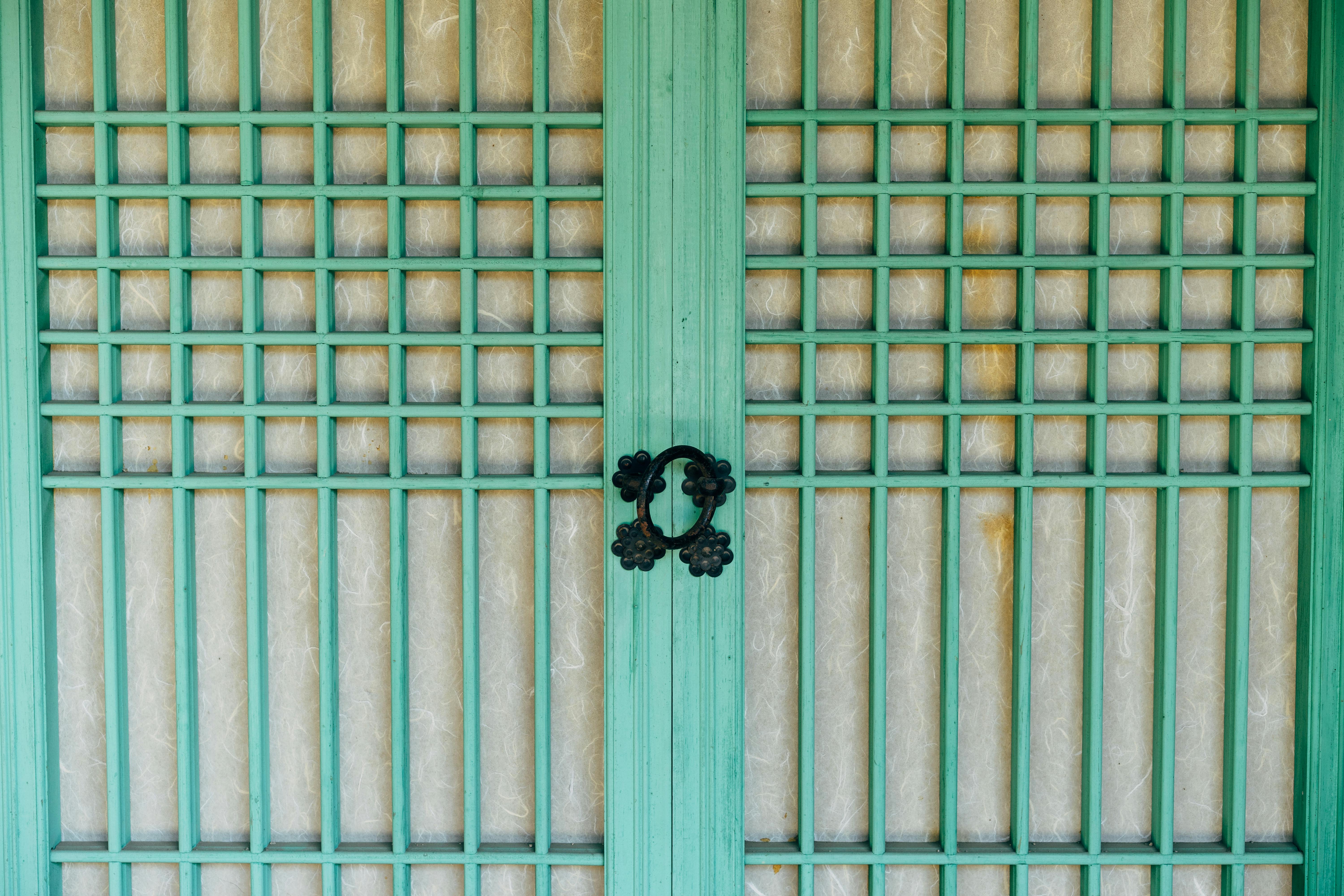 green wooden openwork door