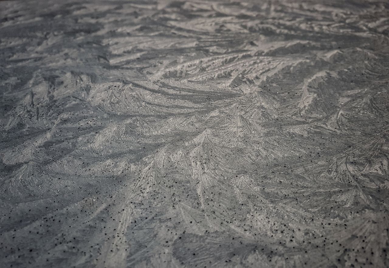 detailed close up of frost patterns creating an abstract design on a w