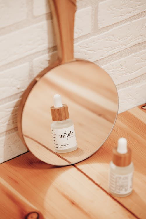 Free Close-Up Shot of a Skin Care Product in front of a Mirror Stock Photo