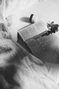 Grayscale Photo of a Book on a Bed