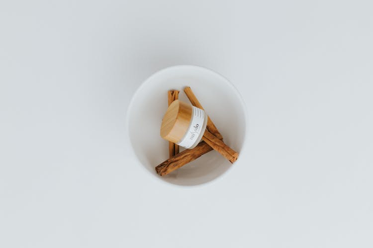 Cream Jar With Cinnamon In Bowl