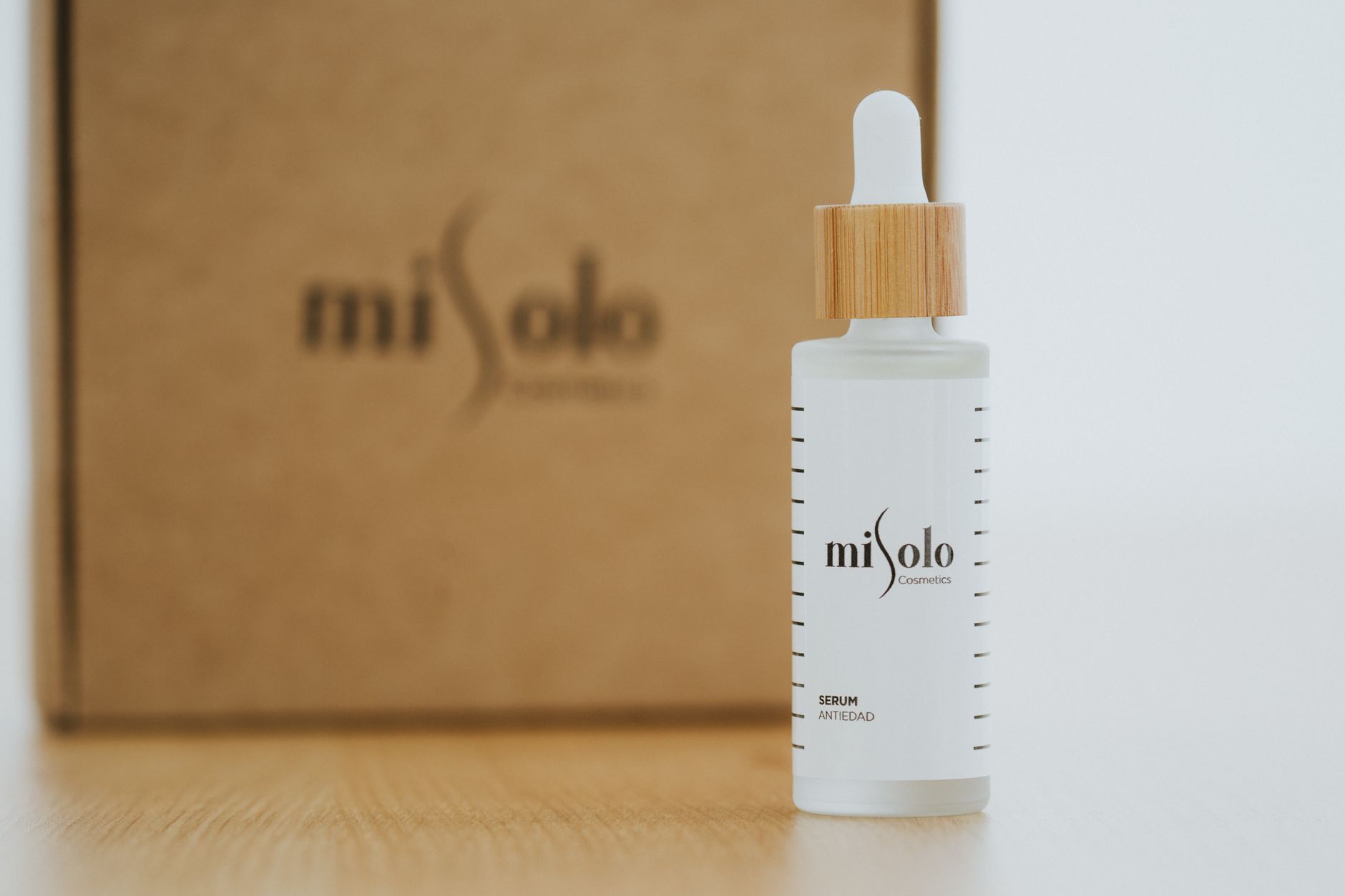 Close-up of a miSolo cosmetics serum bottle with minimalist design, perfect for skincare promotions.