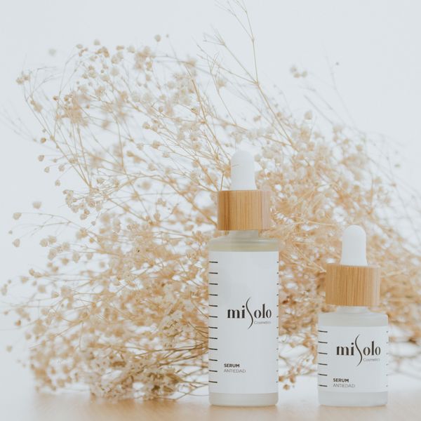Serum bottles displayed with dried flowers, photo by Misolo Cosmetic on Pexels