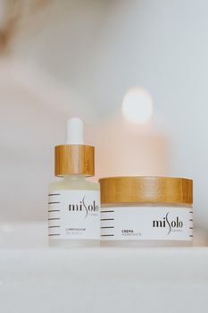 Elegant skincare product display with natural ingredients in a minimalist setting, perfect for cosmetics advertising.