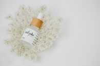 White and Brown Plastic Bottle on White Flowers
