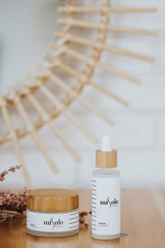 Minimalist skincare products displayed with natural elements and soft lighting.