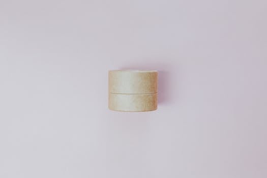 Eco-friendly cosmetic jar on a pastel background, perfect for skincare branding and minimalism themes.
