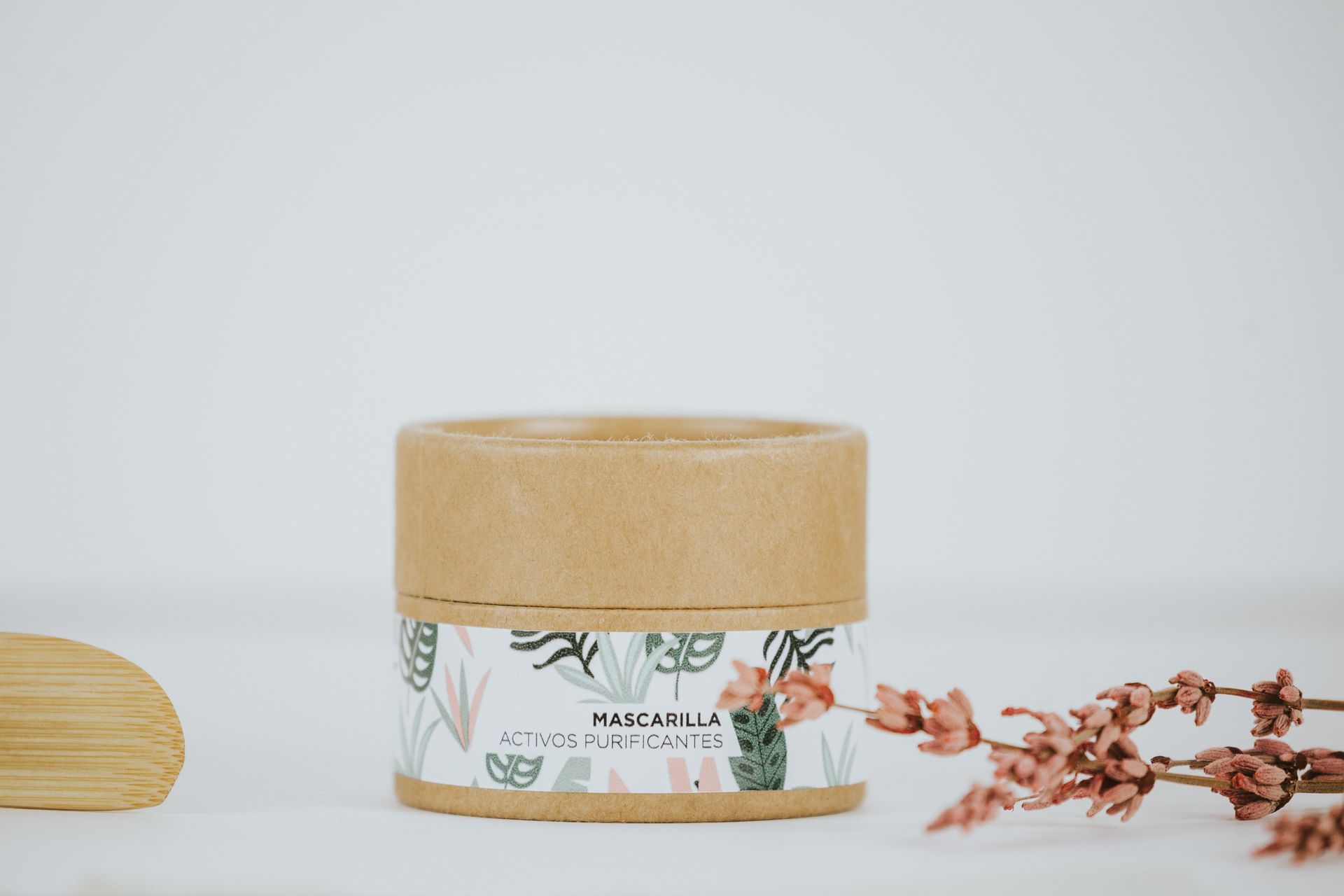 Close-up of an eco-friendly cosmetic product with botanical design, set on a minimalist background.