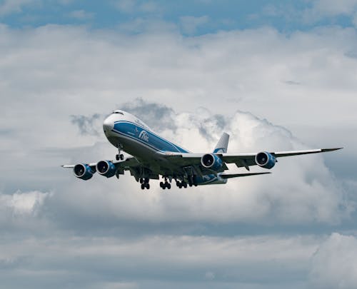 A Blue and White Airplane Flying 