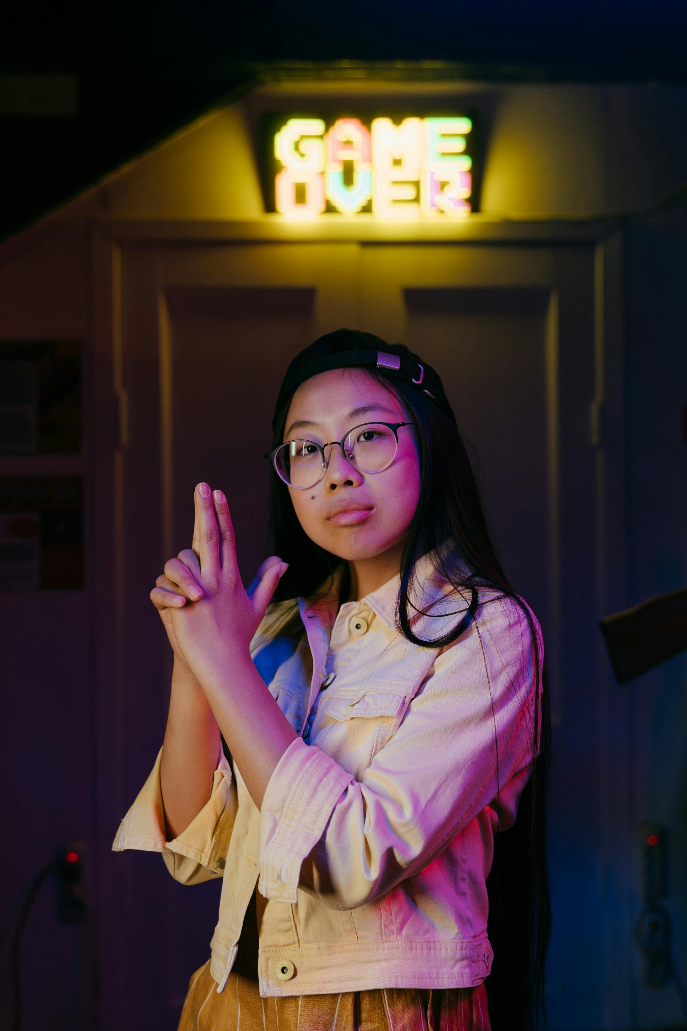 woman in pink dress shirt wearing black framed eyeglasses