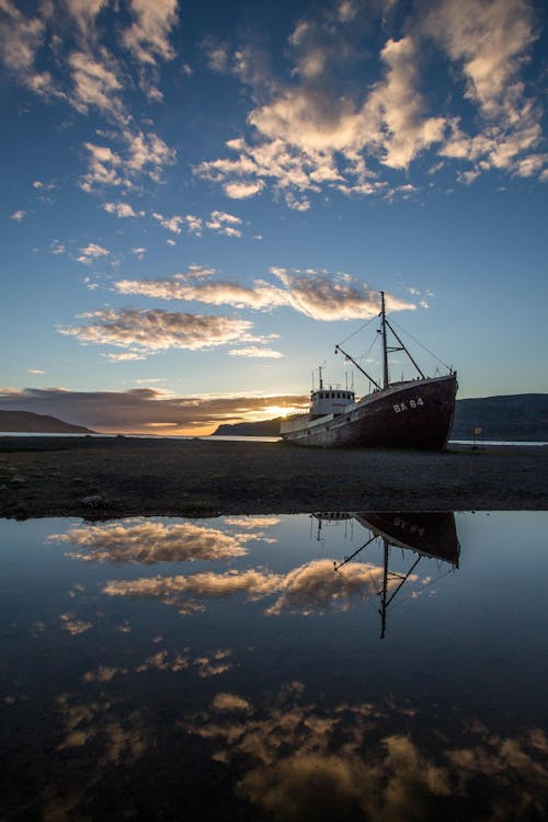 Boat on Water Under Blue Sky during Sunset