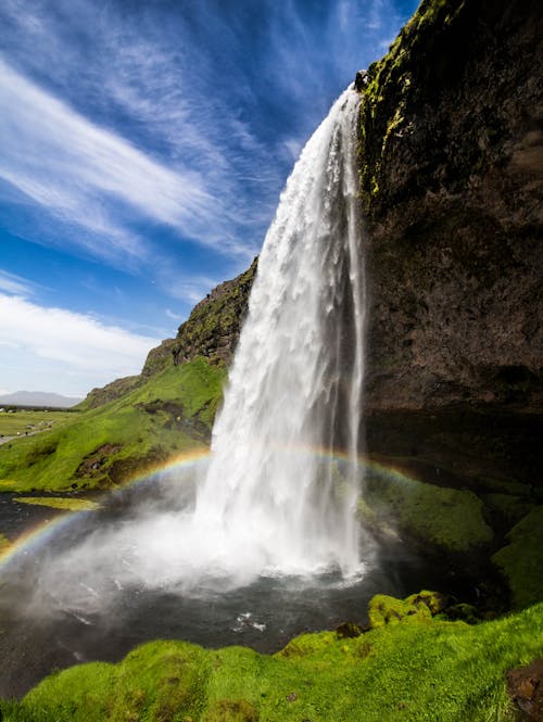 Free Rainbow Over Waterfalls Under Blue Sky Stock Photo