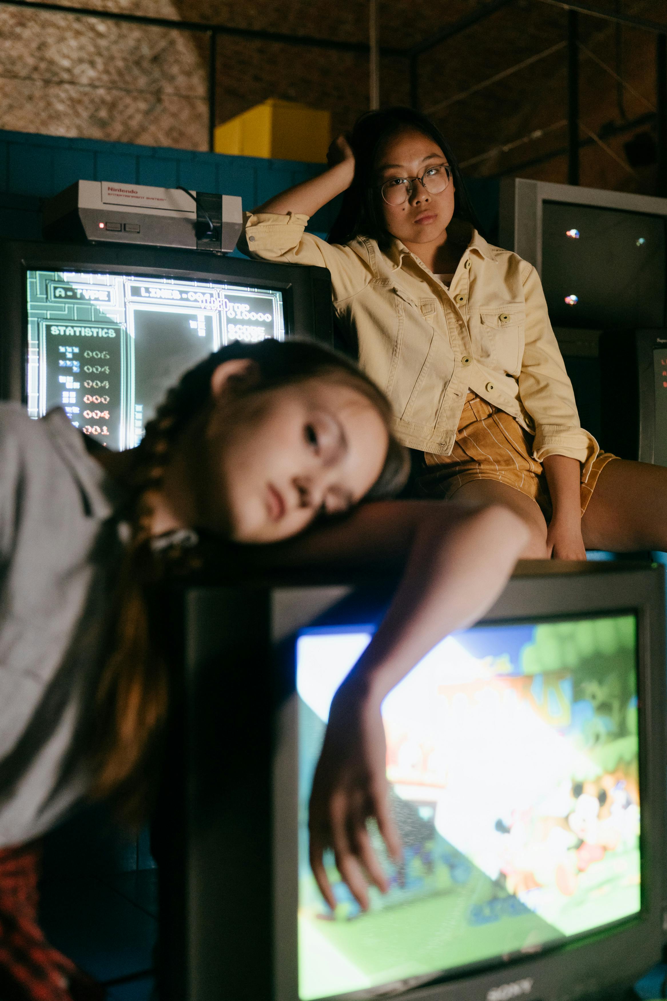 cool multiethnic teens near tv monitors at work