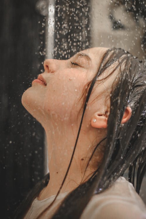 Free Woman's Face Under Rain Shower Stock Photo