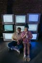 Man in Pink Dress Shirt Sitting Beside Woman in Pink Dress