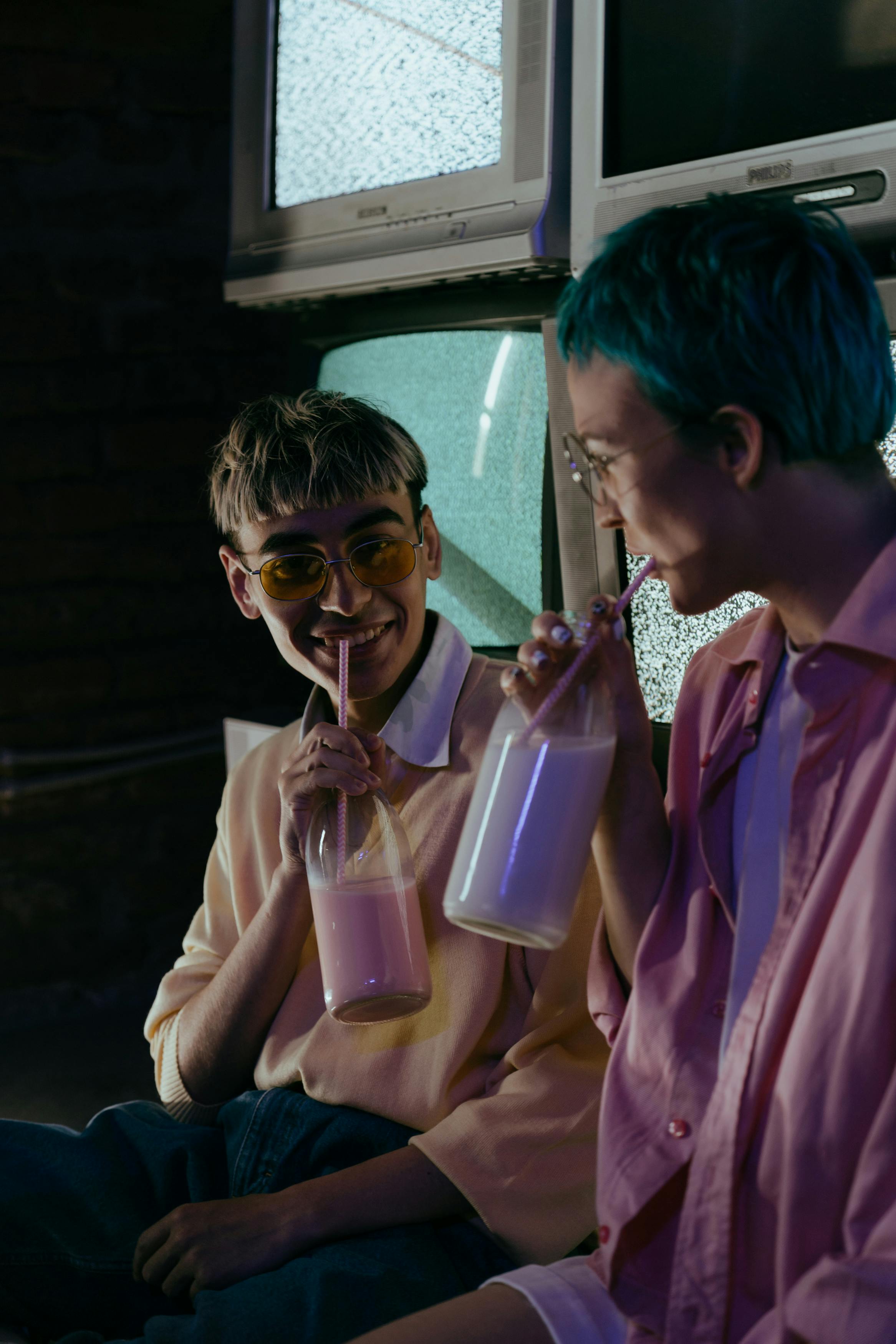 woman in pink dress shirt holding pink plastic cup