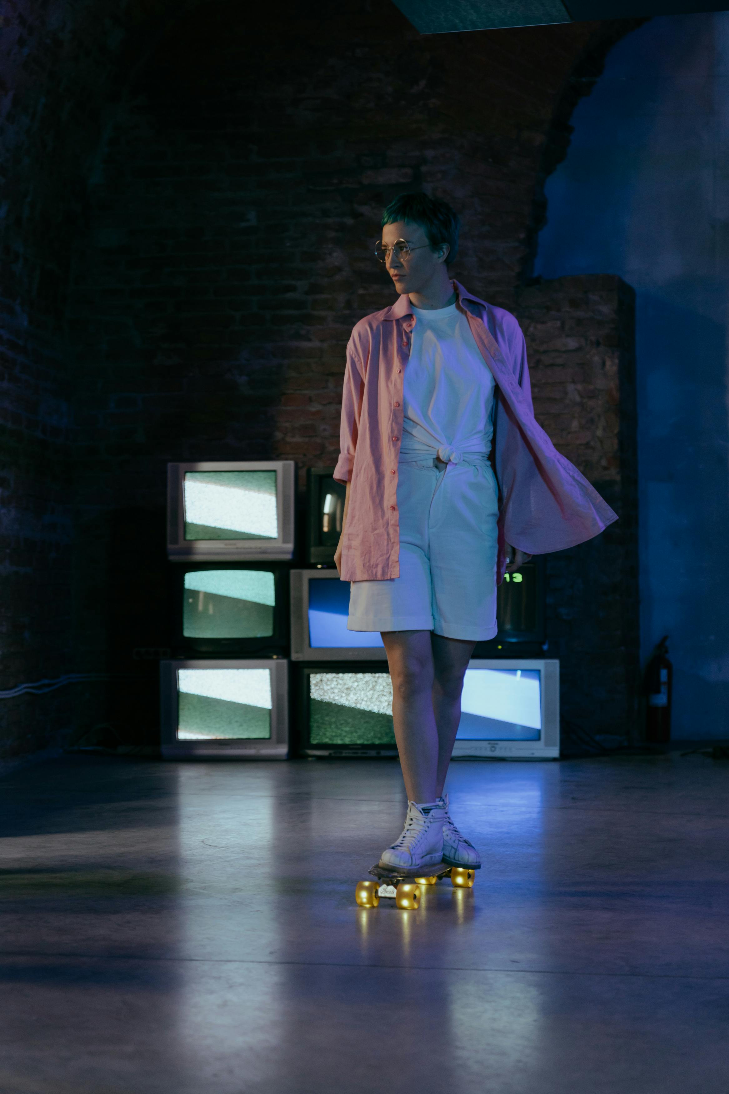 woman in pink blazer standing near black flat screen tv