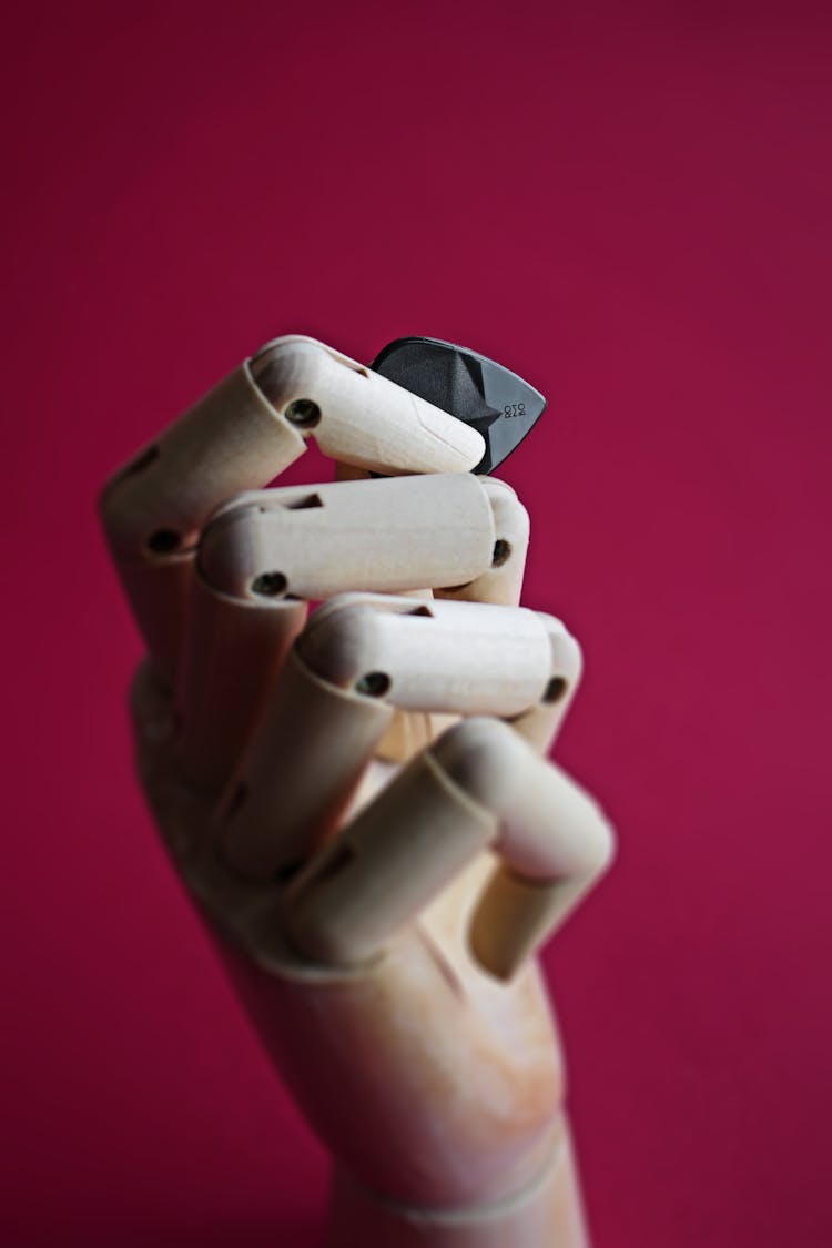 Prosthetic Hand Holding A Guitar Pick