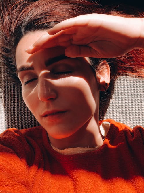 Woman Covering Face From Sunlight