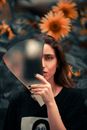 Portrait of Beautiful Woman Posing with Piece of Glass